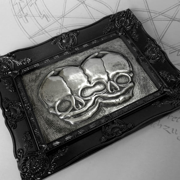 A Curious Elixir - 'Conjoined Fetal Skulls' - hand embossed repoussé metal wall art