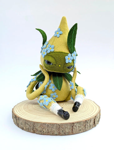 Hannakin - 'Forget Me Not' - wool felt, thread, Sculpey, glass beads and mixed media on raw pine wood base